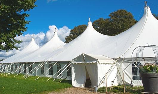 a line of portable restrooms in a shaded area, offering a comfortable experience for users in Aynor